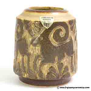 michael andersen & son short vase, in brown medium relief against a tan background, motif of a large -horned stag repeated around the outside of the vase.