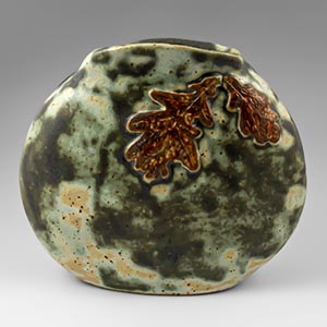 Flat, oval vase decorated with fall leaves by unknown manufacturer